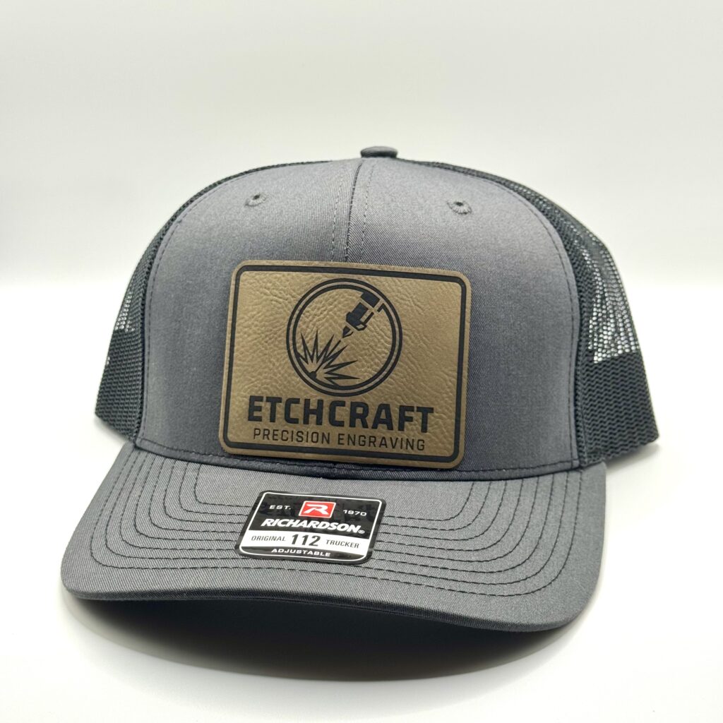 Trucker Hat featuring a custom engraved leather patch with EtchCraft business logo