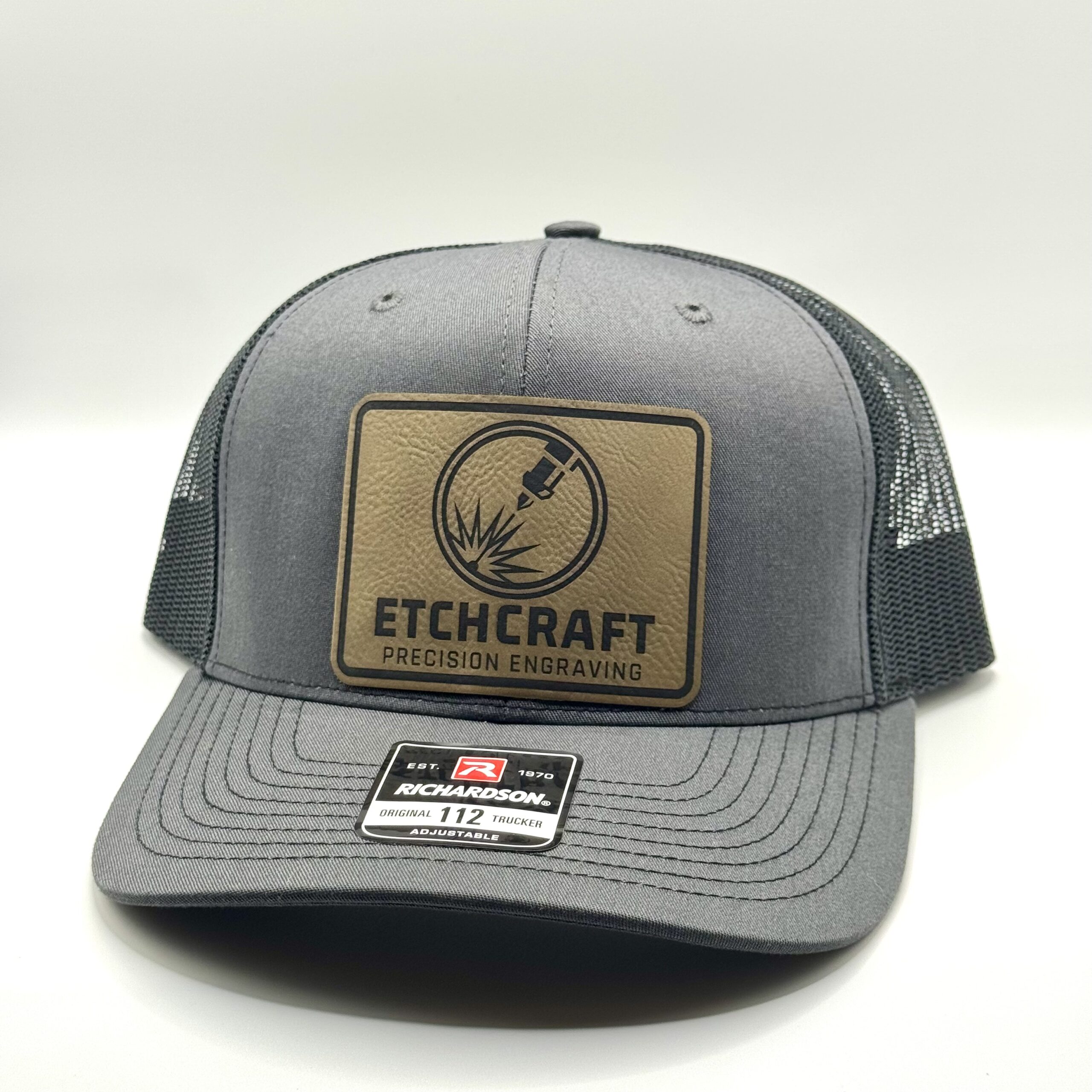 Trucker Hat featuring a custom engraved leather patch with EtchCraft business logo